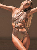 Gold women's one-piece swimsuit with backless and sleeveless design on a mannequin.