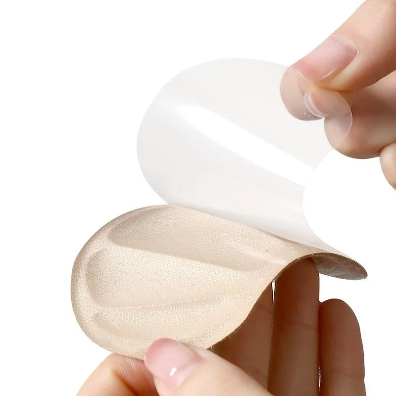 Three pairs of camel-coloured suede heel cushion pads with adhesive backing