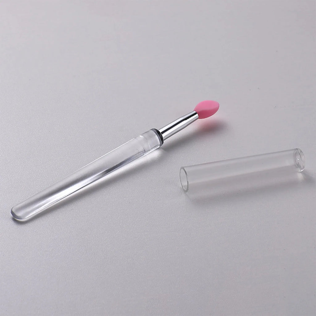 A reusable silicone lip brush with a handle and protective cap, shown in one of eight available colours.