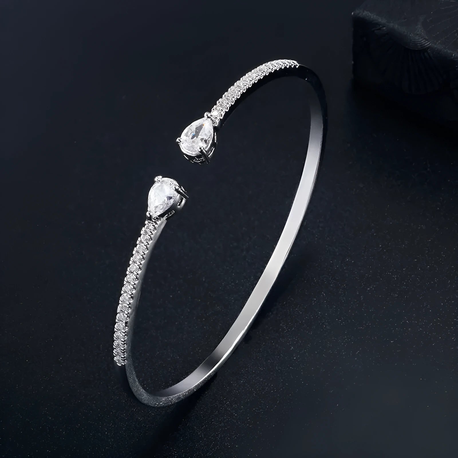 Copper bracelet with inlaid white zircon crystals on a simple band.