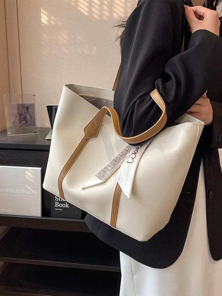 Soft large capacity tote bag with crossbody strap in khaki colour showing outer pocket and sewing line detail