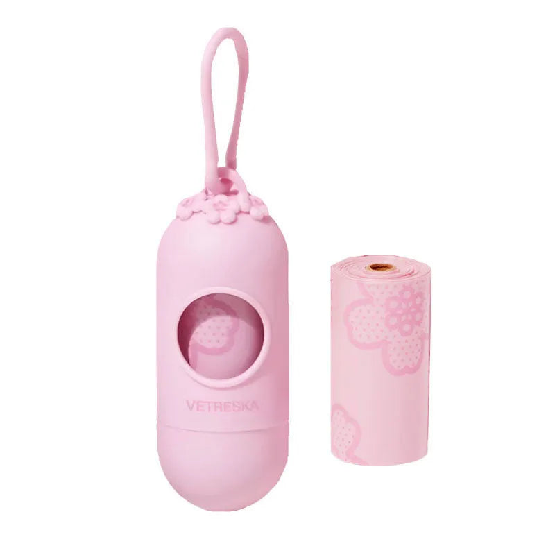 Portable dog poop bag dispenser capsule in strawberry, orange, and cherry blossom patterns with a roll of scented bags.