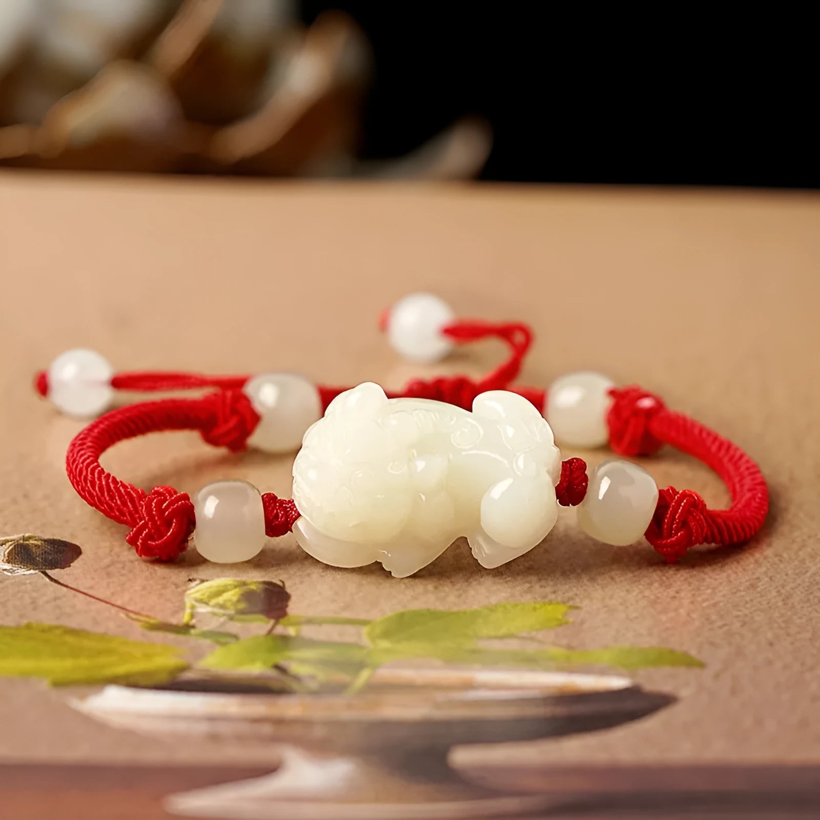 Hetian Jade bracelet with a black and red braided rope band and a central jade bead.