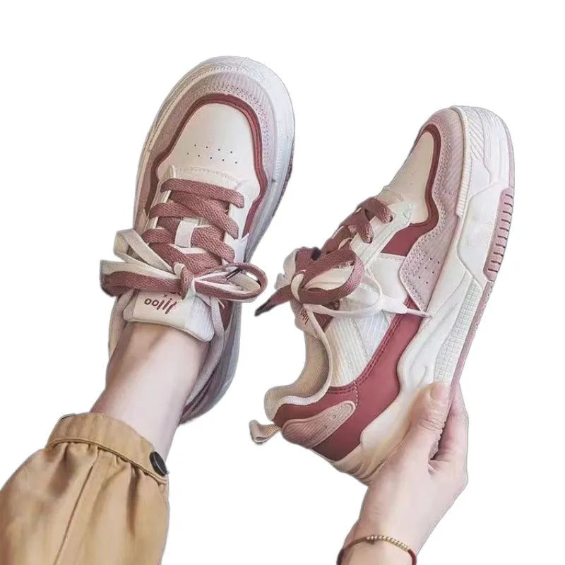 Women's pink and white low-top sneaker with rubber sole for height increasing