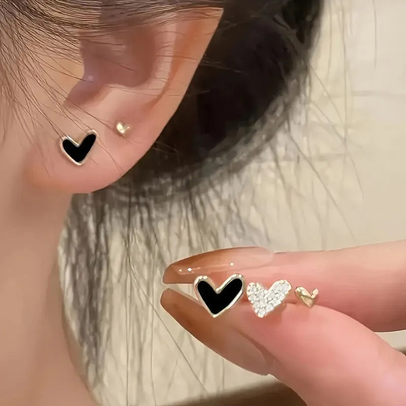 Three pairs of heart shape alloy earrings with electroplated gold, black, pink, and black-white colour options