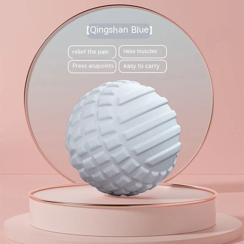 Blue TPR foot massage ball with spiky texture on wooden surface
