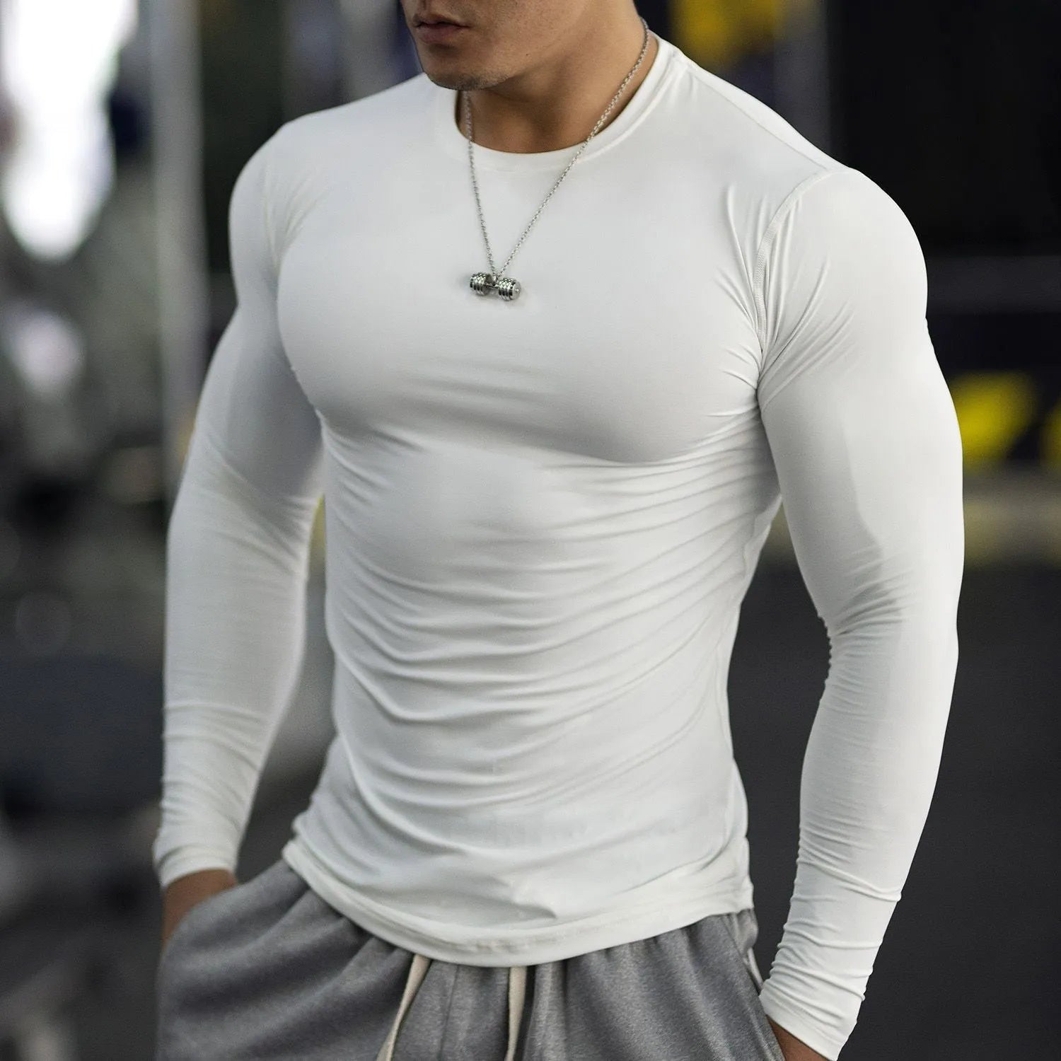 Man wearing black slim-fit long sleeve fitness tights for running or gym workout