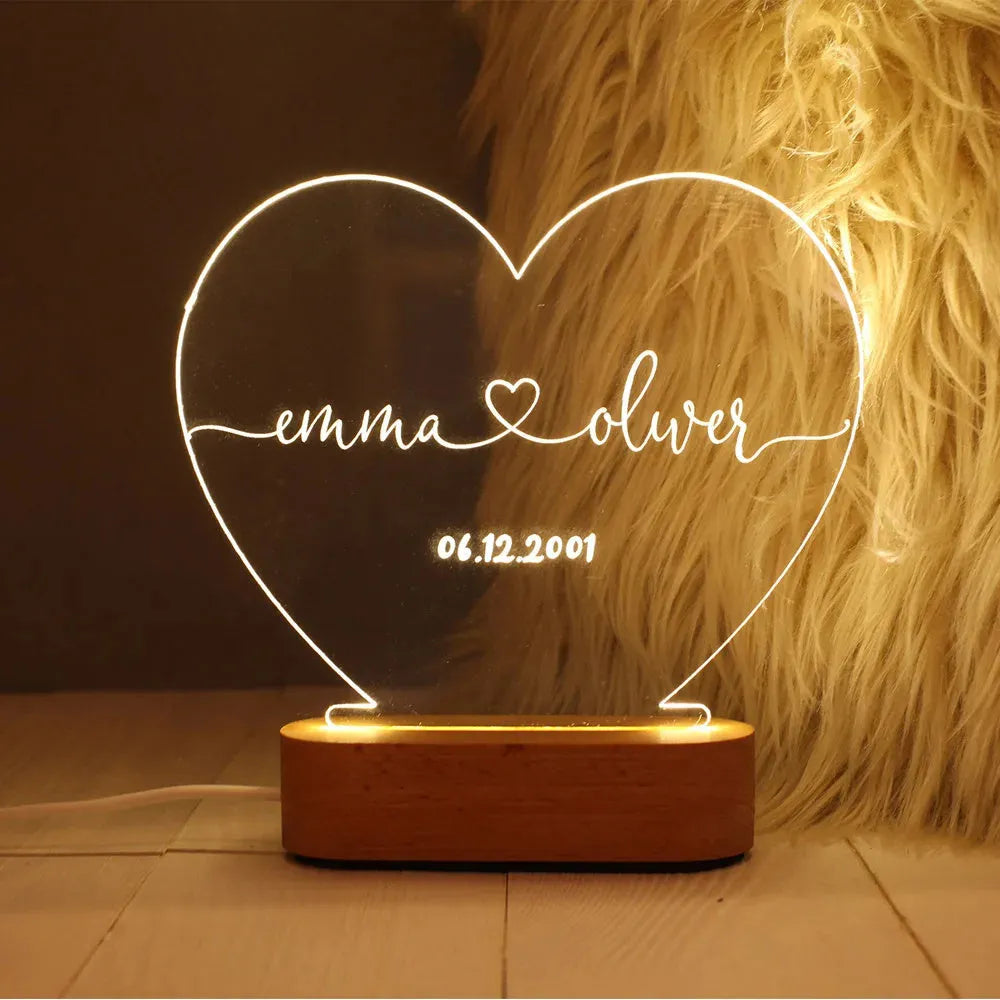Custom transparent acrylic night light engraved with names, lit by LED base, dimensions 20cm by 11.5cm.