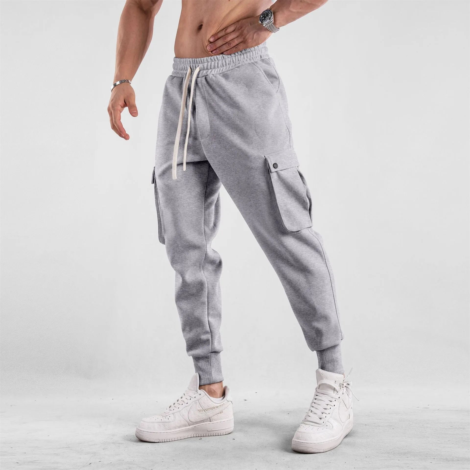 Men's loose light gray cotton trousers with ankle-tied cuffs and multiple pockets