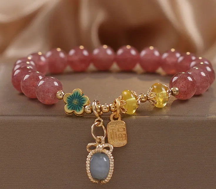 Red strawberry quartz and rhinestone beaded bracelet with an alloy clasp.