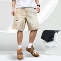 Men's light blue denim shorts with ripped detailing and a straight-leg cut.