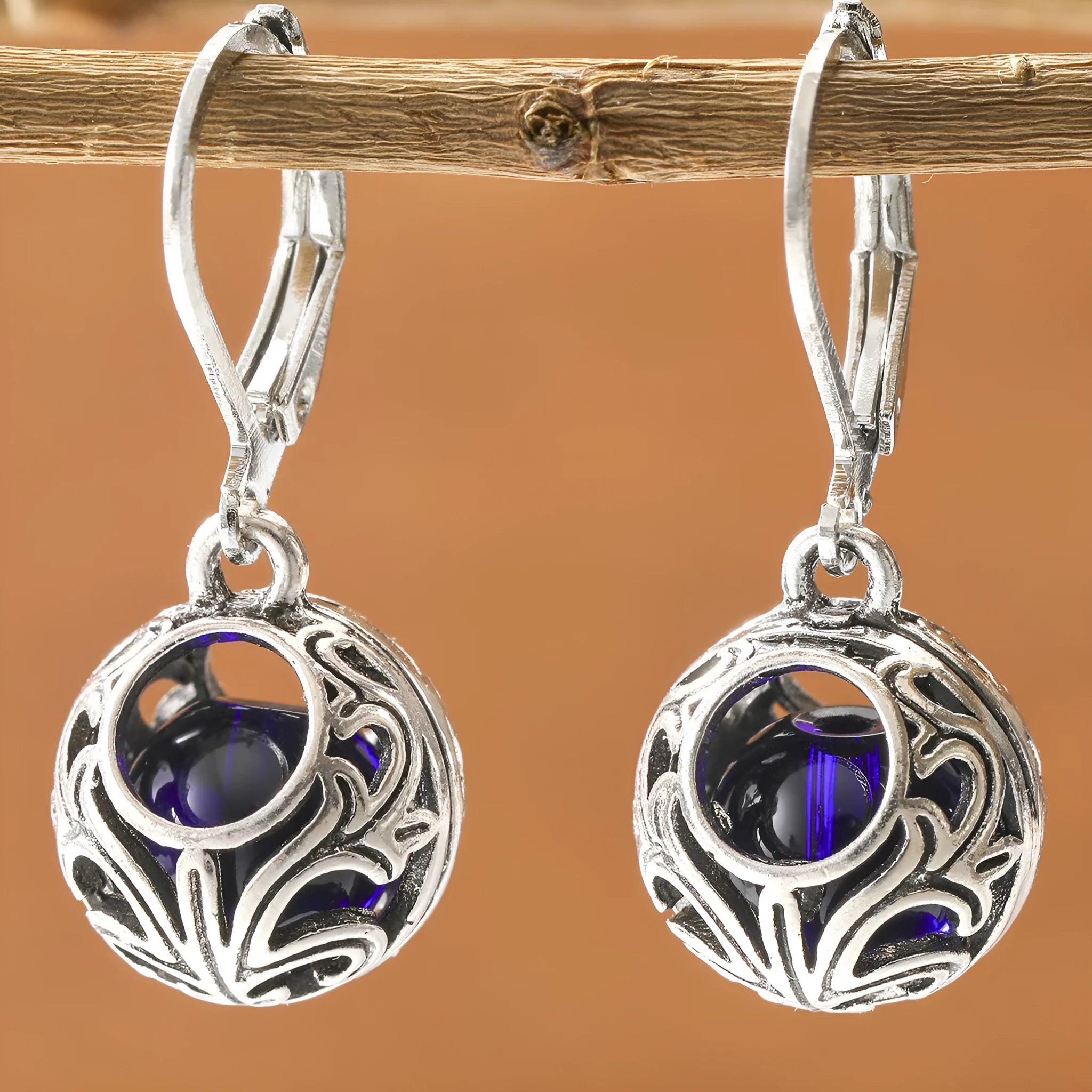 Vintage geometric silver tone pendant earrings with hollow blue gemstone setting