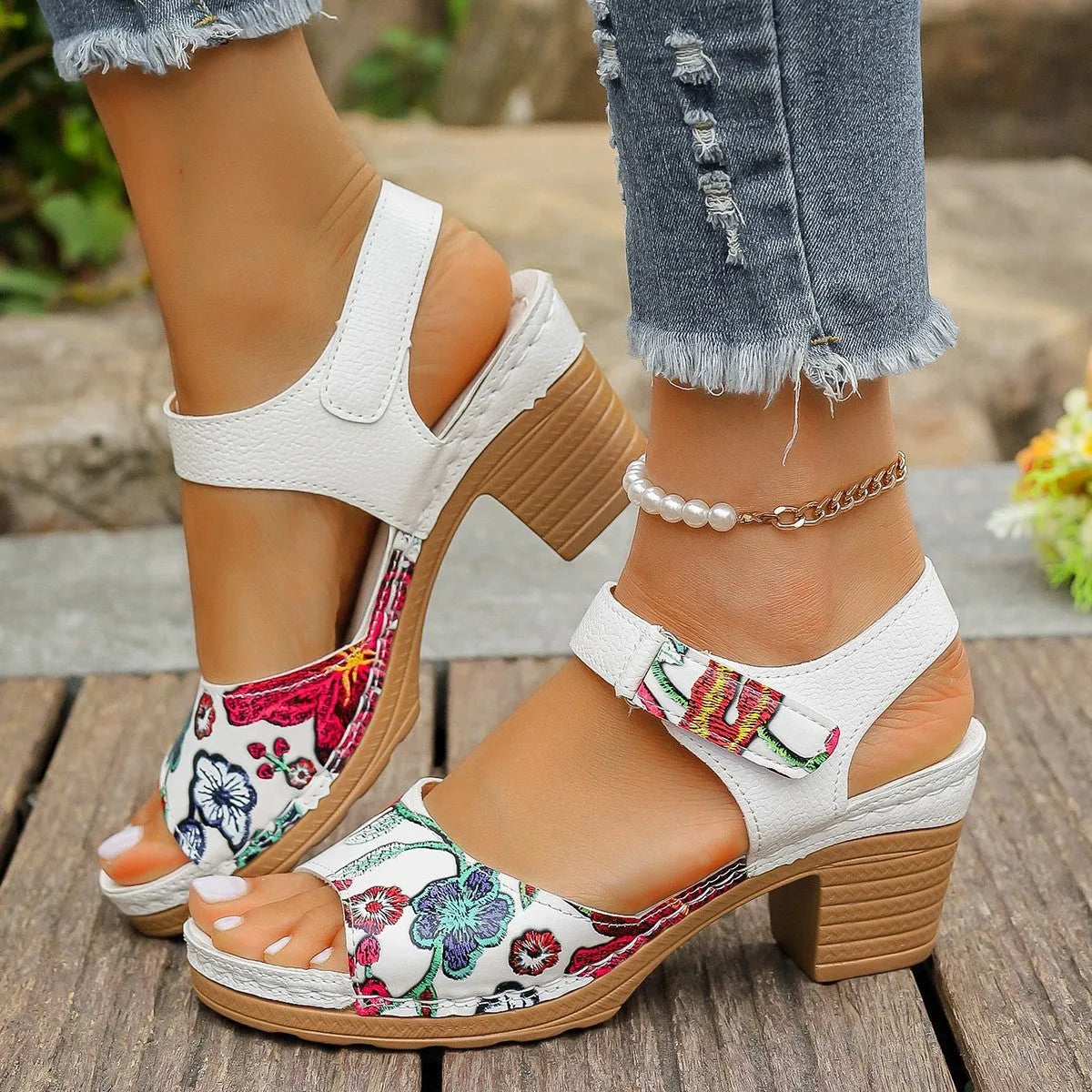 White women's high heel sandals showing the velcro buckle fastening on the strap.