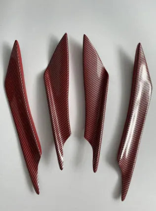 Set of four carbon fibre effect ABS plastic bumper air knife spoilers for car styling.