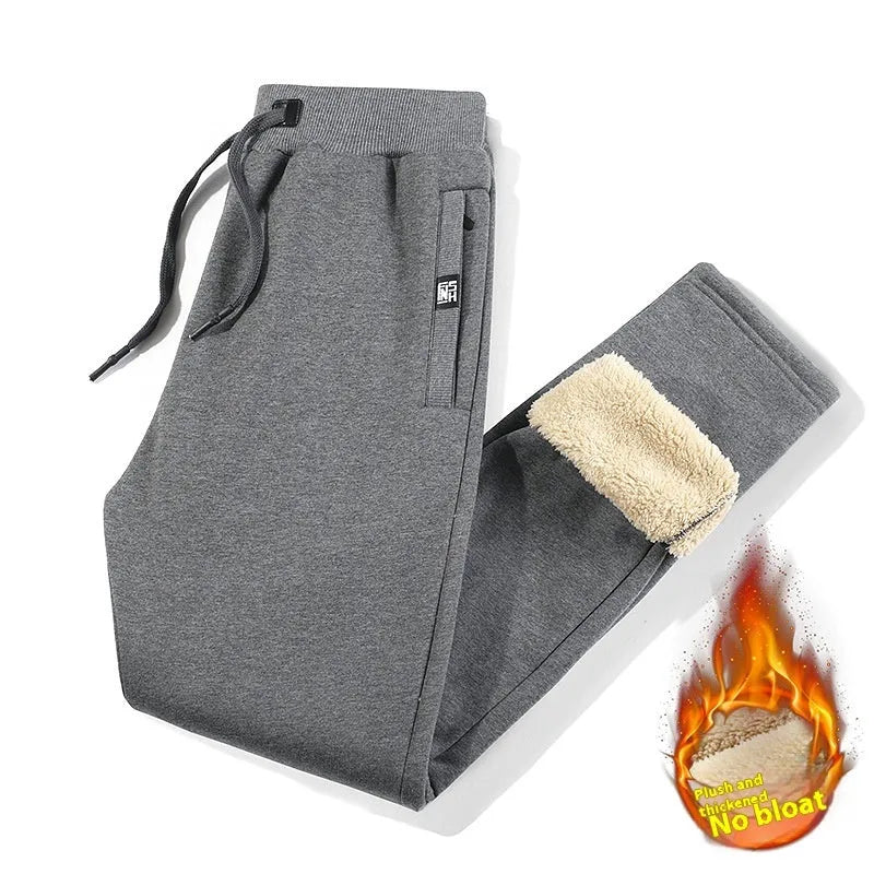 Grey fleece-lined men's oversized track pants with elastic waistband laid flat.