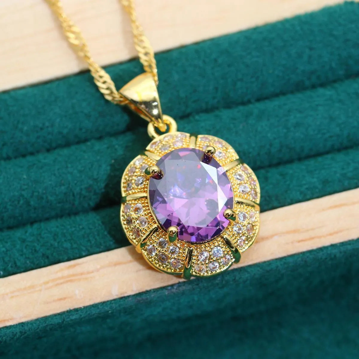 Gold plated jewellery set with multi-colour cubic zirconia stones, featuring a necklace, earrings, a ring, and a bracelet.