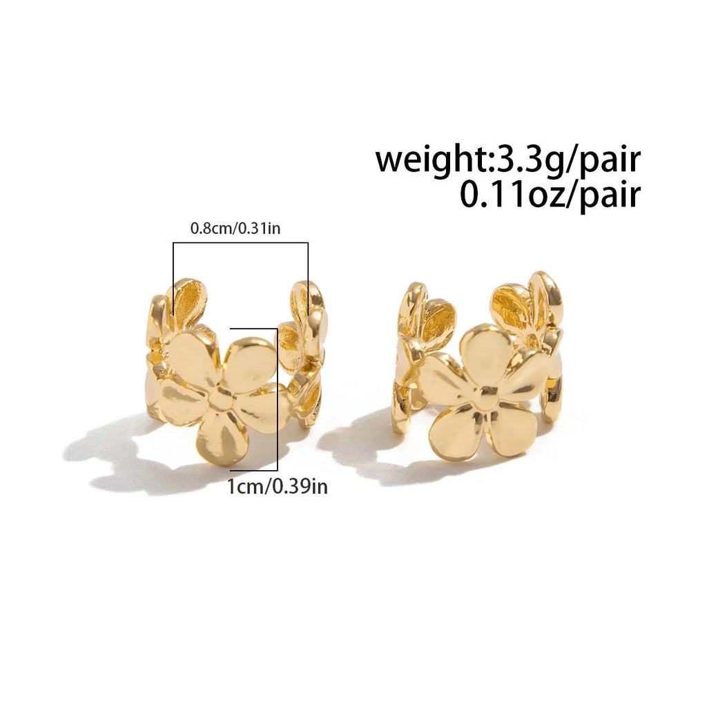 A pair of gold drop earrings featuring starfish and conch designs on an alloy base.