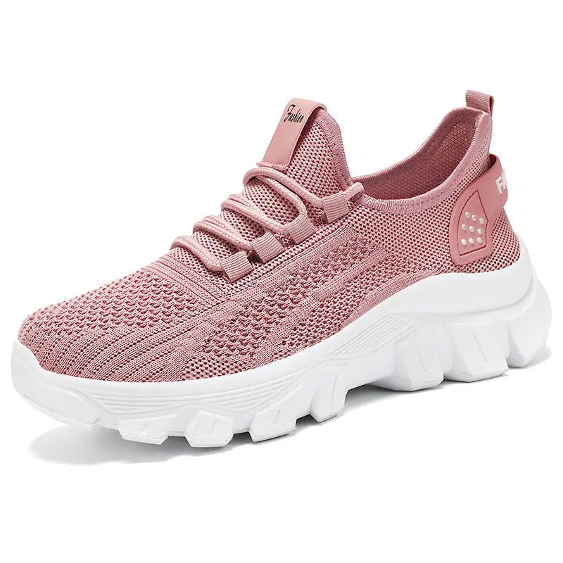 Men's white Flyknit sneakers with a thick PVC sole and round toe on a plain background.