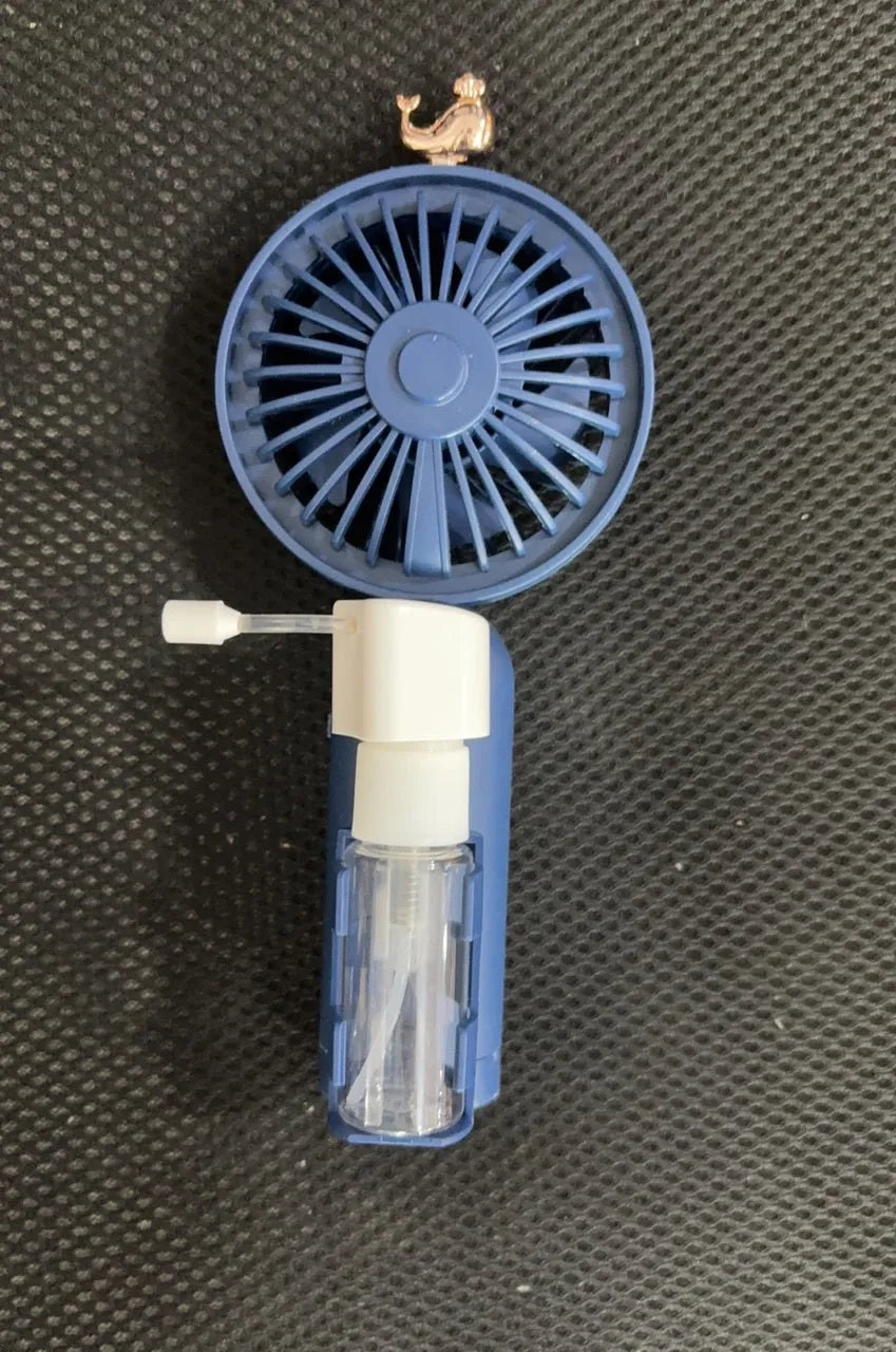 Plastic USB desk fan with a flexible nozzle in apricot colour on a wooden desk.