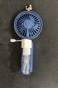 Plastic USB desk fan with a flexible nozzle in apricot colour on a wooden desk.