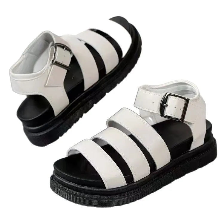 Black thick-soled beach sandals with an adjustable buckle strap and round toe.