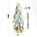 Small 24-inch white artificial Christmas tree with LED lights and snow spray on plastic branches