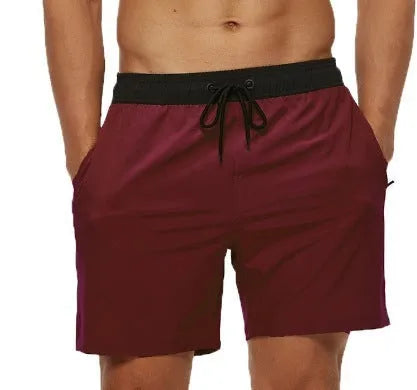 Men's blue fitness shorts with stitching waist detail, drawstring, and multiple pockets for gym workouts
