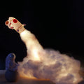 DIY astronaut rocket night light kit with LED string lights, small model, and straws for assembly on a desk.