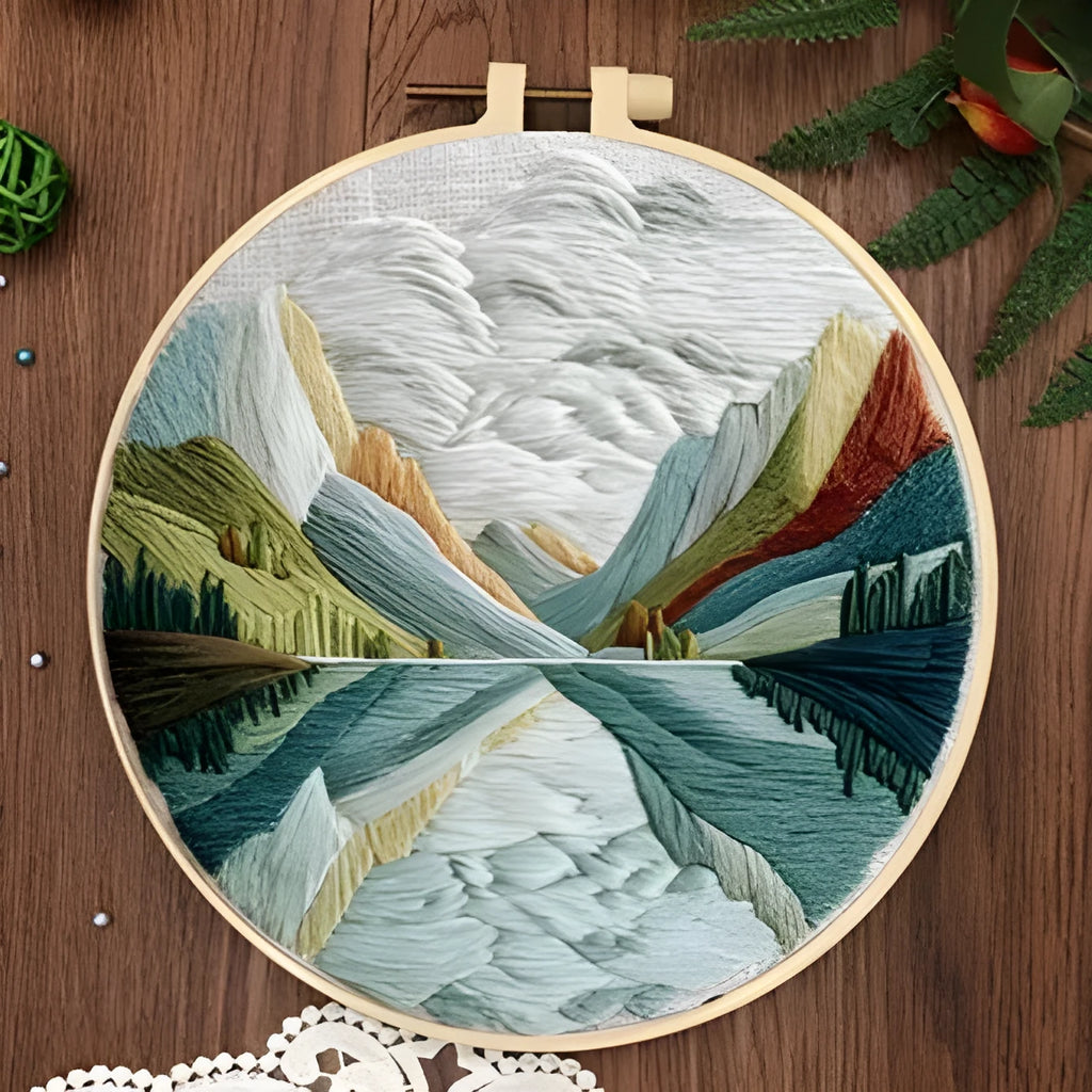 Embroidery kit with cotton fabric, bamboo frame, threads, and printed landscape design for DIY textile art