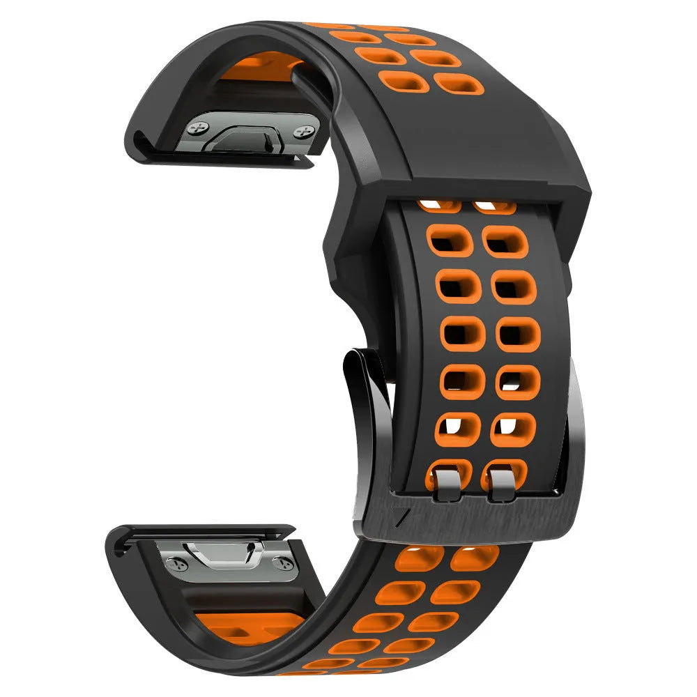 Close-up of a two-tone black and orange silicone watch strap with quick-release pins and a pin buckle.