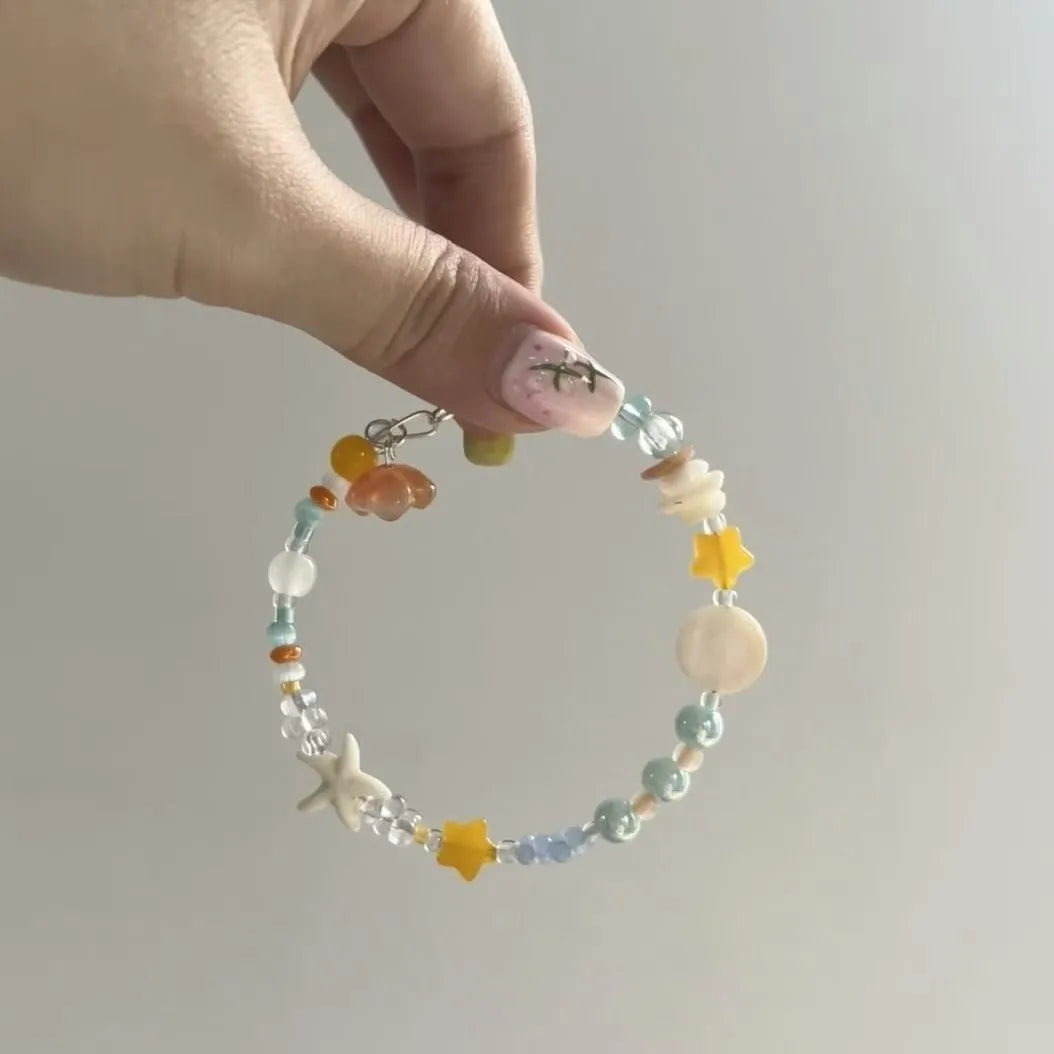 Orange alloy charm bracelet with mixed materials, diamond and round elements, adjustable seaside summer design