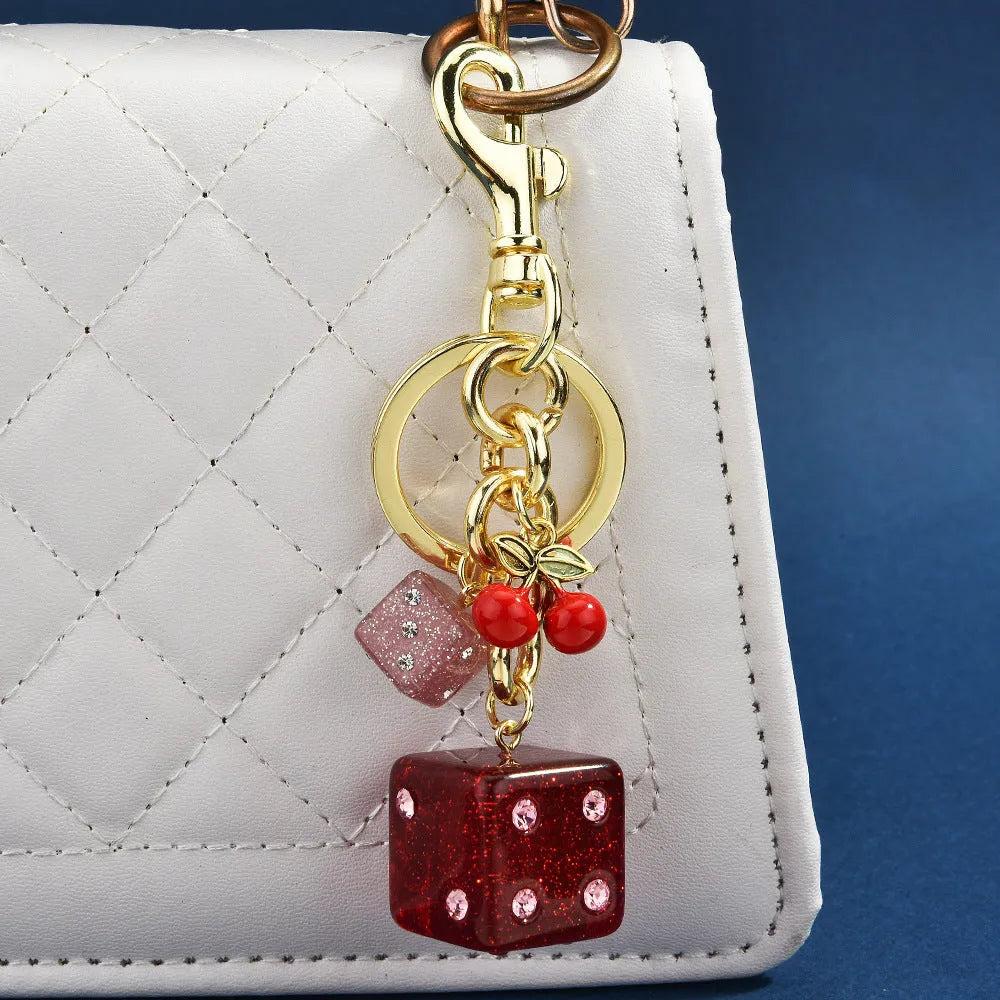 Cherry two-tone dice keychain pendant with square pattern metal design
