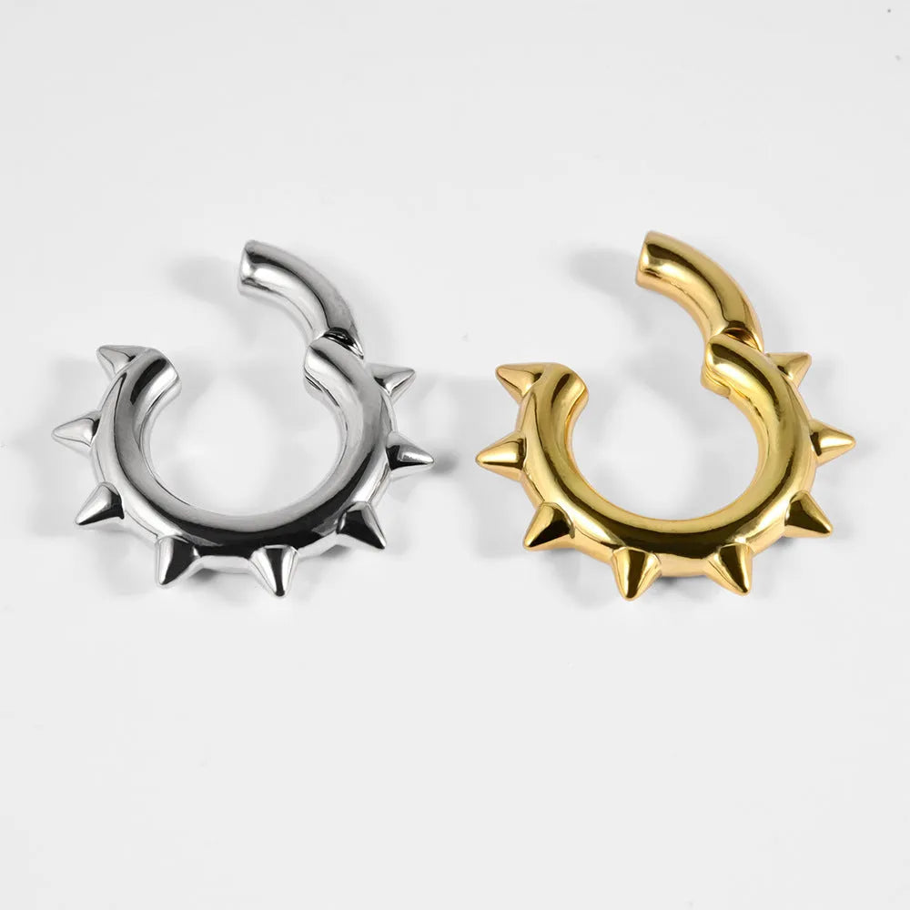 A pair of geometric sharp cone and round copper ear extenders with a magnetic closure in a silver finish.