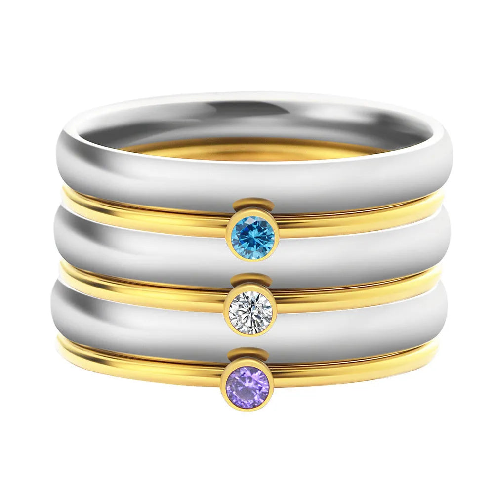 Close-up of a geometric titanium steel women's ring with a December birthstone and engraved pattern.