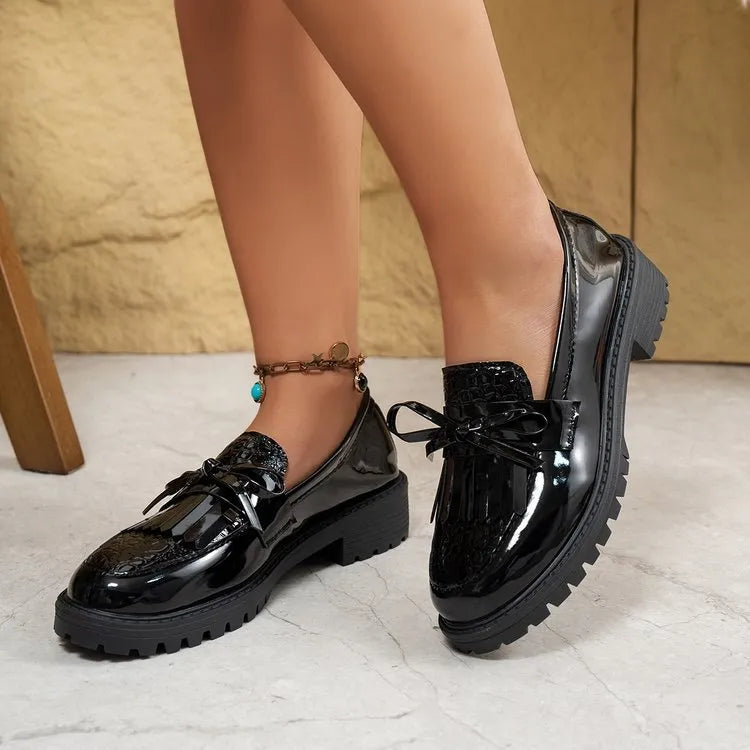 Women's brown and black bow-detailed flat loafers made from artificial PU, shown from the side.