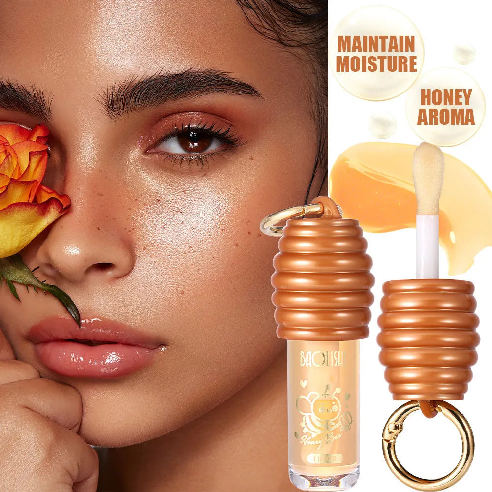 Portable honey lip gloss canister with keychain attachment for moisturising and nourishing lips.