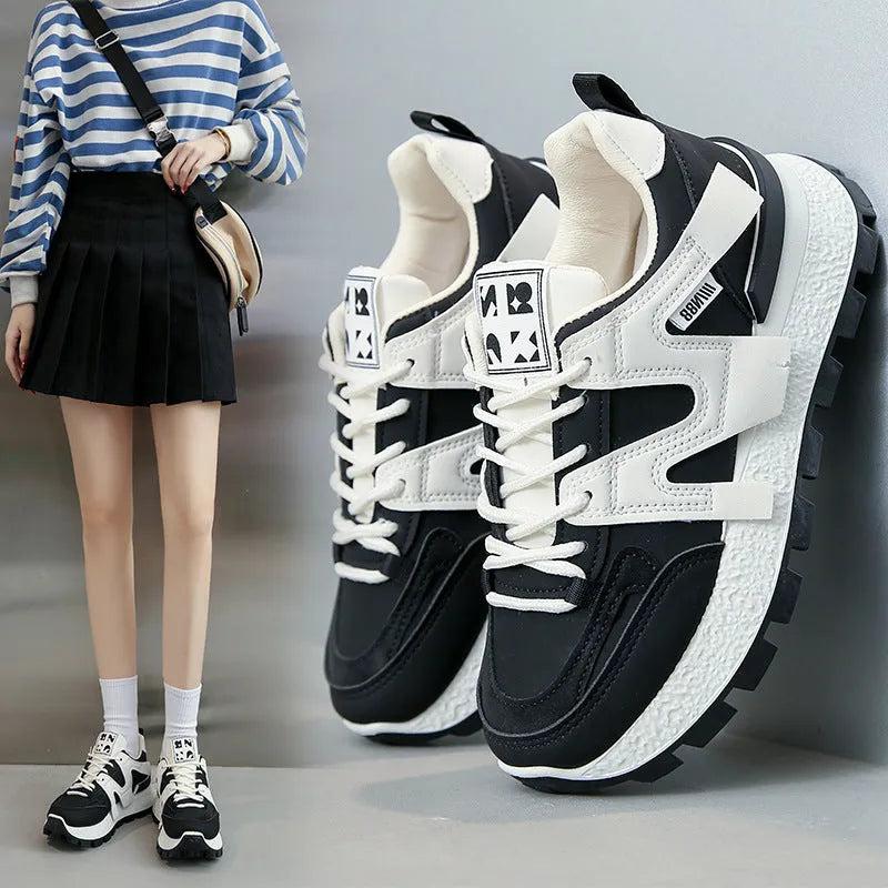 Unisex low-top running sneaker in black with round toe, lace-up front, and rubber sole on a white background.