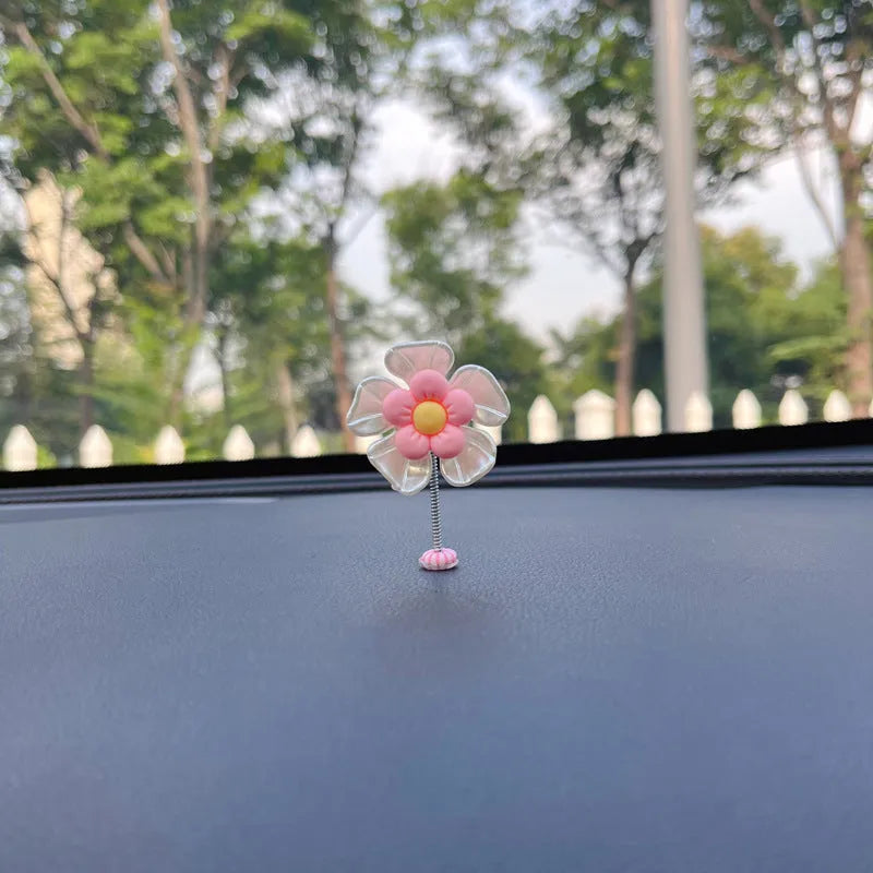 Small plastic swing decoration for car dashboard measuring 50mm by 35mm in multiple colours