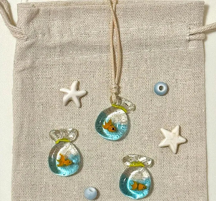 Women's necklace with Small Fish Lucky Bag glaze pendant on a cotton linen chain.