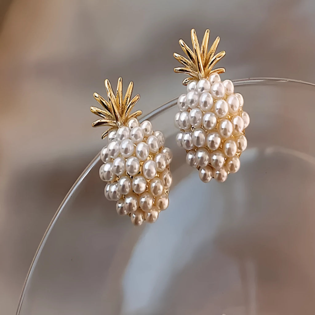 Korean style gold pineapple starfish pearl earrings made from electroplated alloy with inlaid stones.