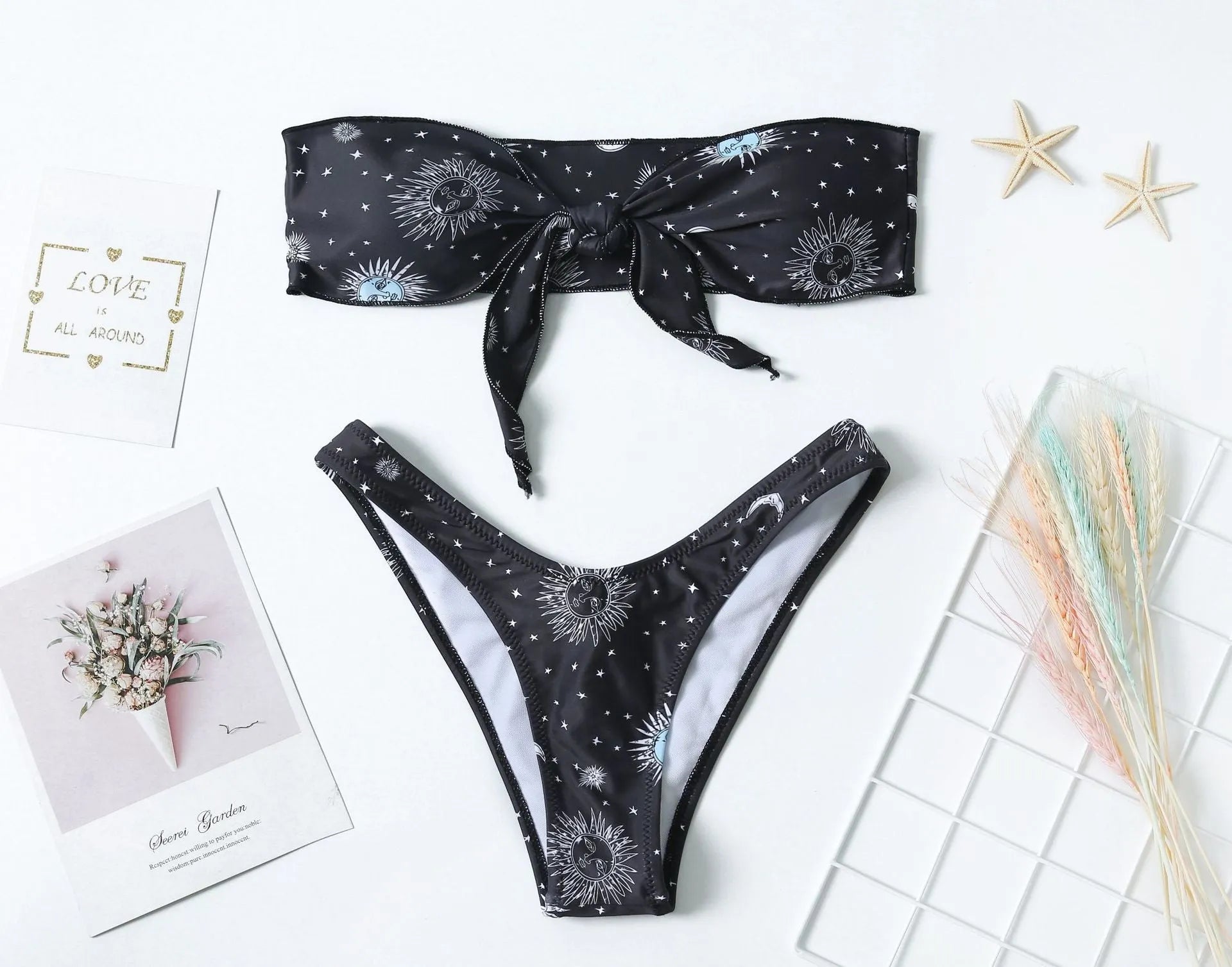 Black one-piece swimsuit with bikini print and a backless split tube top design.
