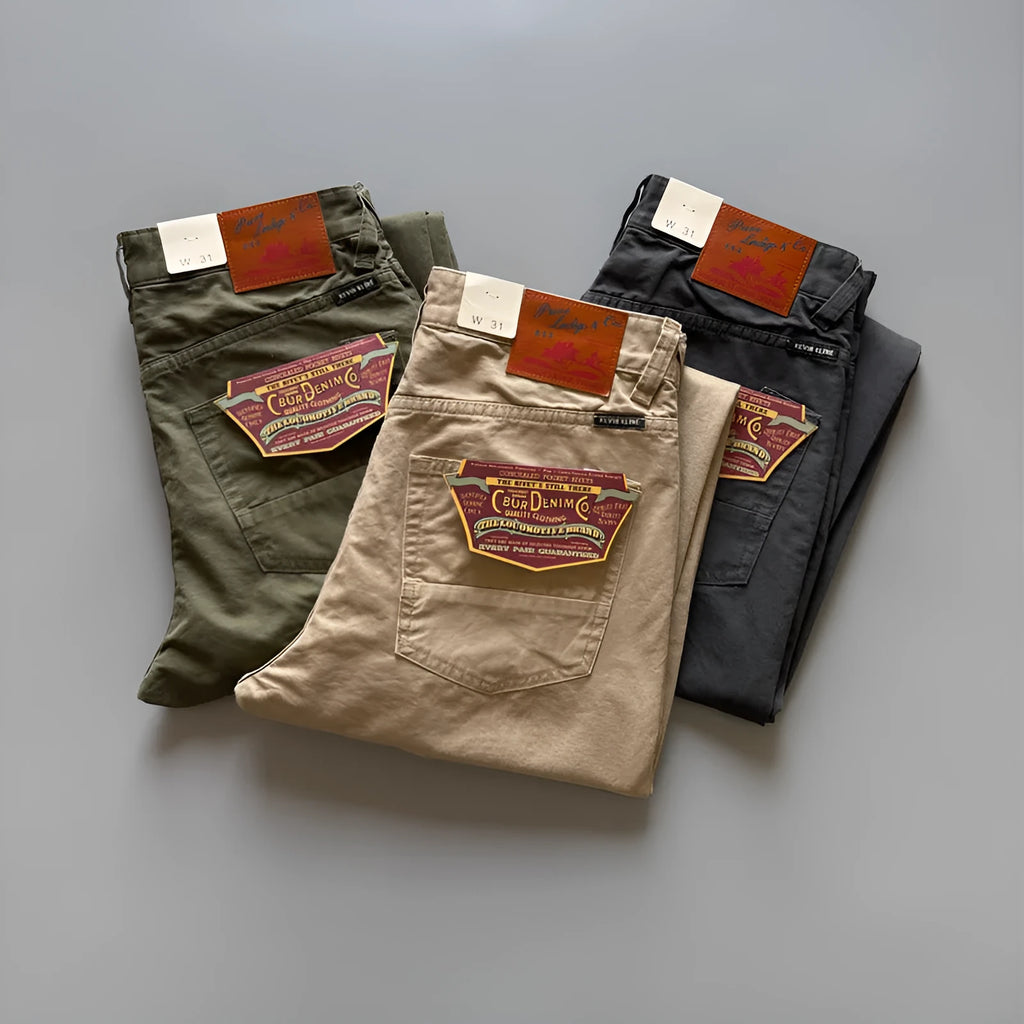 Men's grey straight-leg cotton casual trousers laid flat, showing mid-waist and inelastic design.