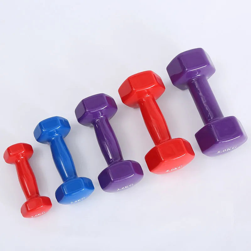 Set of bright red and blue plastic fitness dumbbells on a light floor.