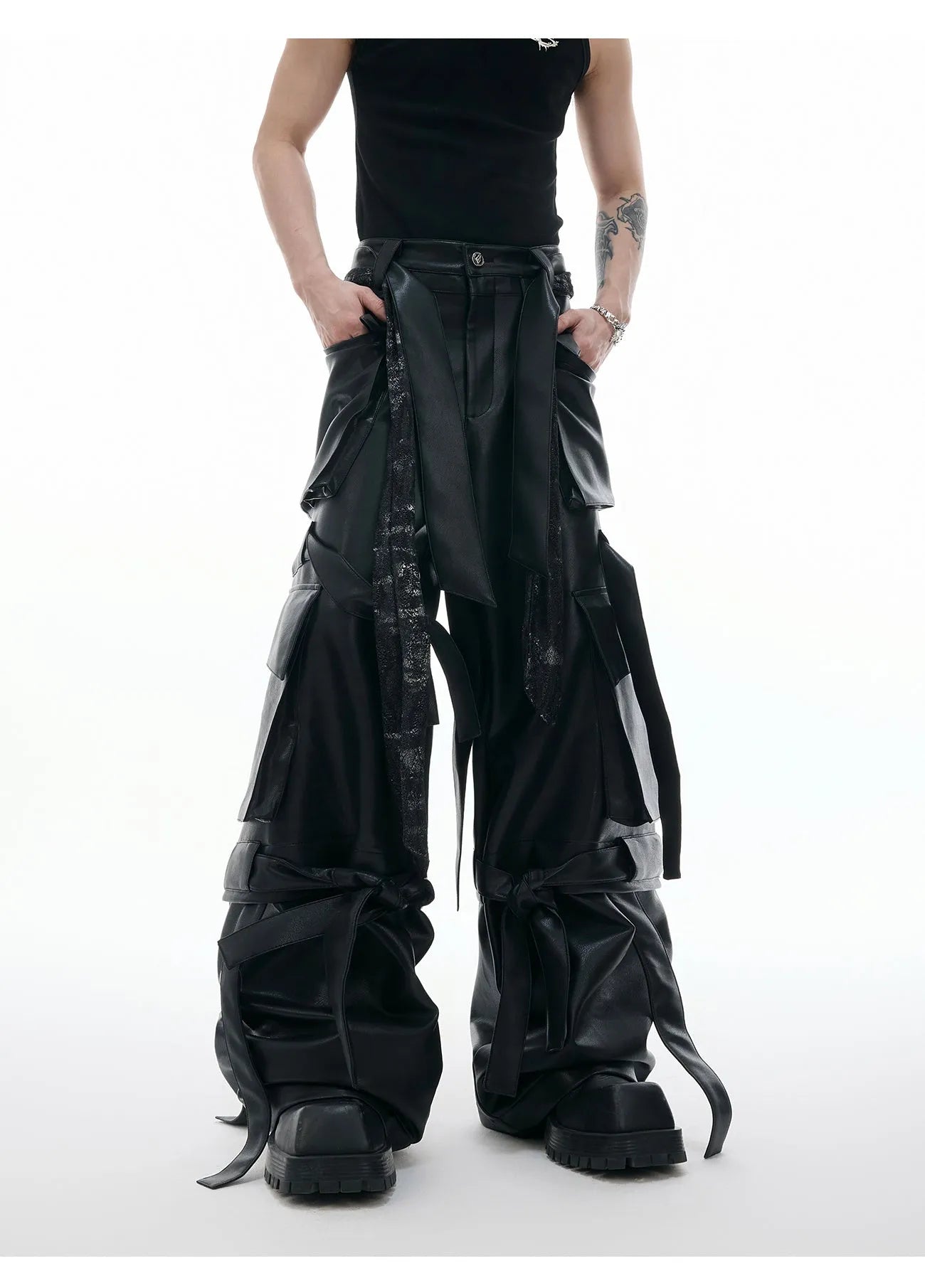 Black loose-fit retro leather-look pants with quilted texture and multi-pocket stitching detail.