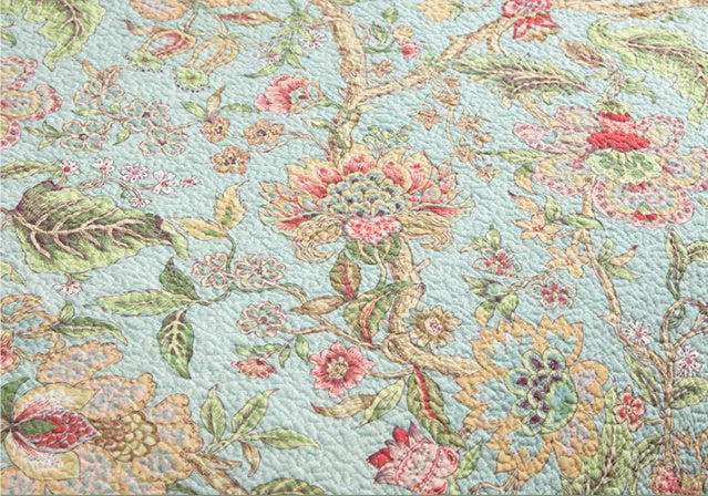 Blue American-style cotton bedspread with floral bird pattern and quilting texture