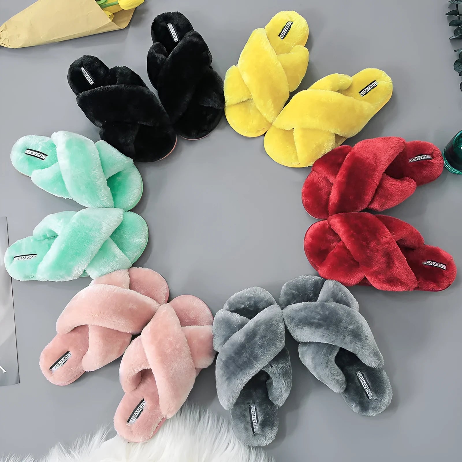 Women's black cross open-toe fur slippers with a patterned anti-slip sole.