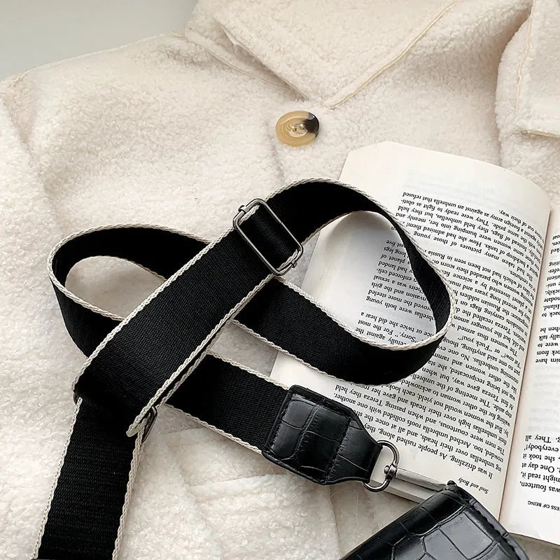 Vintage-style black PU leather crossbody bag with dimensions 20cm by 14cm by 7cm.