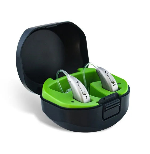 Rechargeable invisible hearing aid and USB charging case on a table.
