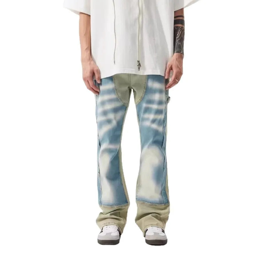 Retro yellow and blue patchwork jeans with splash-ink damaged design showing front and back views