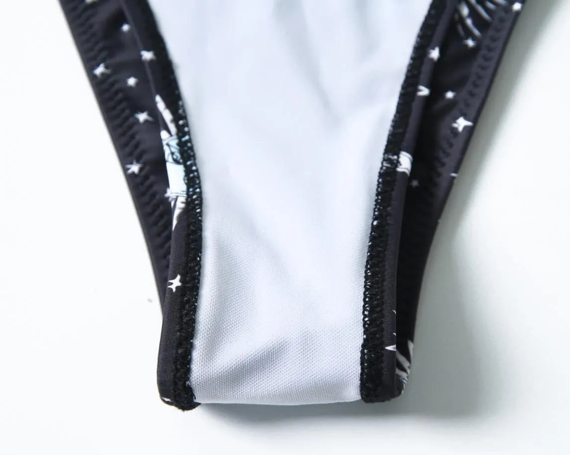 Black one-piece swimsuit with bikini print and a backless split tube top design.